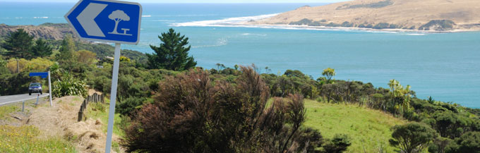  New Zealand travel information road sign near coast